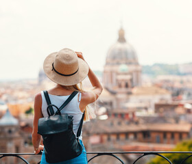 Young attractive smiling girl tourist in hat exploring new Europe city at summer holiday