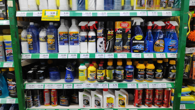 Various car oil and  detergent in bottles on shelves in supermarket