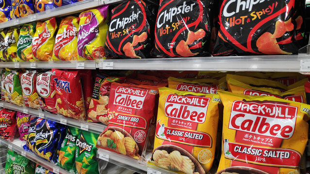 Wide selection of potato chip or junk food on shelf display in a convenient store