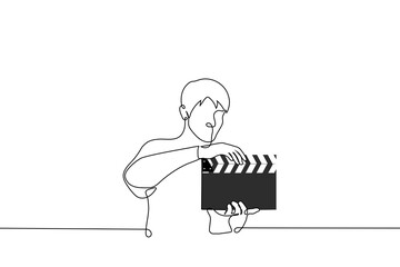 man holding clapperboard - one line drawing vector. filming process concept