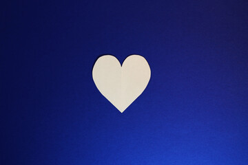 love is a white heart on a blue background