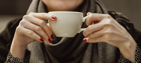 Close up woman hands with red manicure holding coffee cup, vintage toned - obrazy, fototapety, plakaty