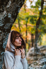 Portrait of a hooded woman among the trees