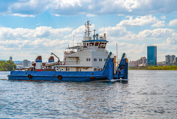 River tug boat is moving along the water