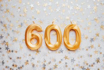 600 six hundred followers card golden birthday candle on Festive Background. Template for social...
