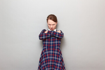 Portrait of angry disgruntled young woman looking from under forehead