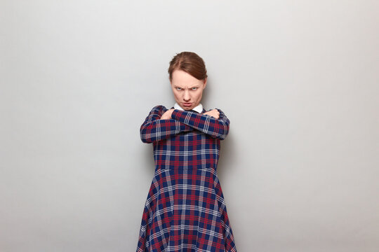 Portrait of angry disgruntled young woman looking from under forehead