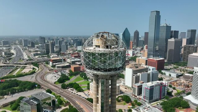 Downtown Dallas TX skyline. Major corporate Fortune 500 headquarters in Texas city. Aerial orbit of Reunion Tower.