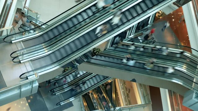 People in escalators at the modern shopping mall. Time lapse.