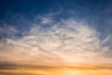Bizarre multicolored clouds in blue sky at sunset