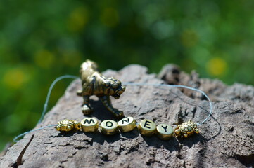 A figure of a metal tiger and the inscription money close-up.