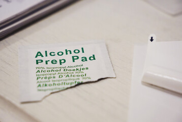 Opened alcohol prep pad package used to clean glass surface                              