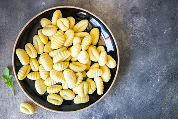 gnocchi dough, potatoes Italian food cuisine fresh healthy meal food snack diet on the table copy space food background rustic top view