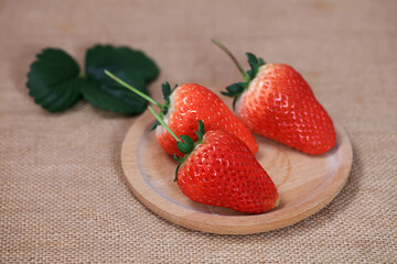 Fresh strawberries on the plate, fresh strawberries on the table