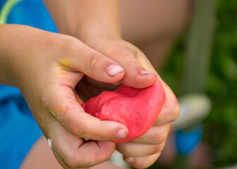 children's hands with self-made slime, slime making at a birthday party, close up of a little child is hand playing a slime