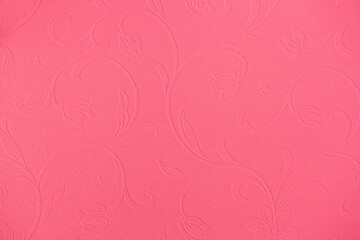 Fototapeta premium Pink background of decorative plaster with abstract spots. Unusual texture of this wall with beautiful patterns, creative surface background. Finishing coating for building cladding.