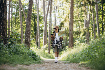 Obraz premium Girl scout looking on the map and phone in the woods