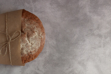 round buckwheat bread on a gray background under concrete