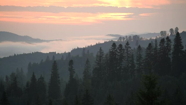 Sunset in foggy mountains time lapse
