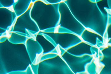 Sunflecks on emerald water surface in a swiming pool