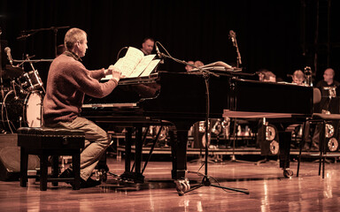 Big Band: jazz pianist. A piano player referring to his music in the studio. From a series of...