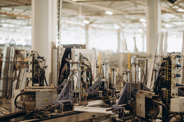 Factory for aluminum and PVC windows and doors production. Details industrial equipment. Background