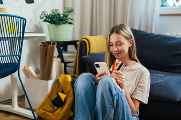 teenager girl using smartphone and shopping online from home