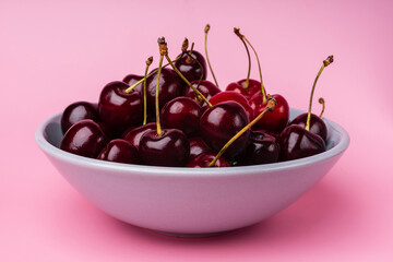 Juice and fresh cherry with leaf and water drops on blue background. Sweet red berry cherries. Summer fruit Background