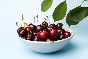 Juice and fresh cherry with leaf and water drops on blue background. Sweet red berry cherries. Summer fruit Background