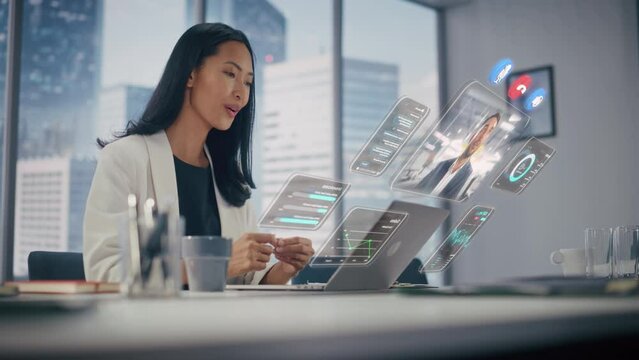 Executive Officer Talking on a Video Call with Business Partner. Laptop Computer with Augmented Reality Conference Stream and Essential Financial and Business Data Appear From Manager's Laptop.