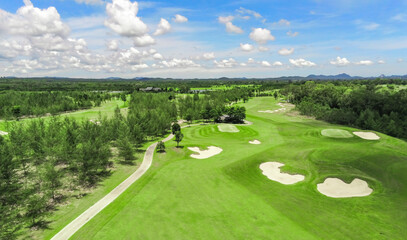 Beautiful green view at golf course ,green trees and mountain blue sky white cloud background	