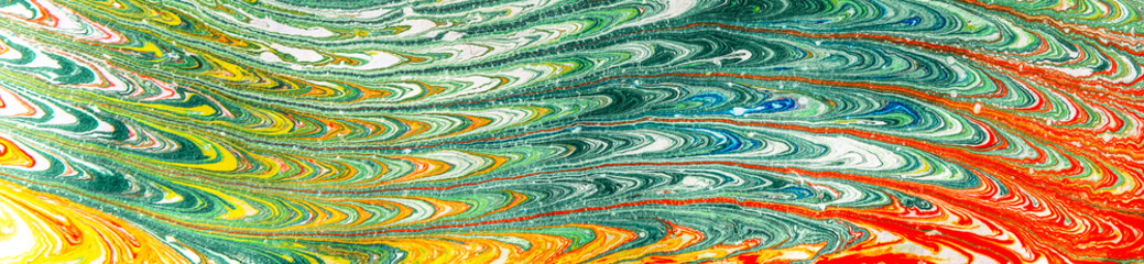 Abstract multicolored drawing with paints on the water.