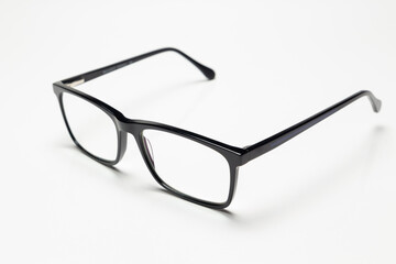 Carbon fiber degree glasses in black color. Side view and white background. Space for text.