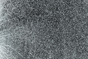 Cracks in safety glass surface. Abstract broken glass mesh texture on black background transparent....