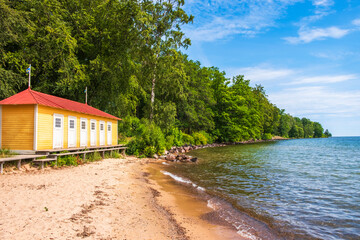 Fototapeta na wymiar Old classic beach hut at a lake in the summer