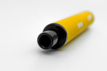 Modern electronic cigarette on a white background. Fashionable smoking device. E-cigarette for vaping. Trendy vape pod. Selective focus