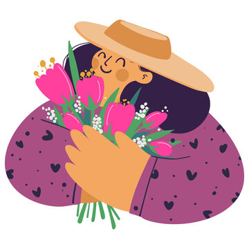 Portrait of a smiling girl in a hat with a bouquet of flowers