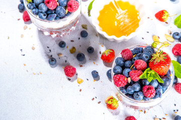 American independence holiday food, july 4 breakfast recipe idea. Summer diet healthy breakfast layered parfait dessert in a glass of yogurt, oatmeal, blueberries, strawberry berries