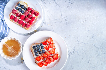 American holiday USA independence food, recipe idea July 4 breakfast or snack - sandwich with toast bread, cream cheese, blueberry raspberry, strawberry