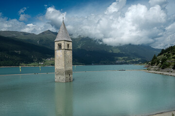 Landscape of the Resia lake with the bell tower in the center, in Italy