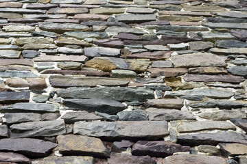 Rustic wall of roughly mortared horizontal fieldstone