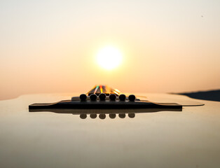 acoustic guitar on the beach at sunset