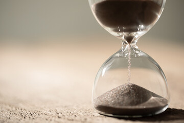 hourglass (sand clock) on the table, Hourglass as time passing concept for business deadline, copy...