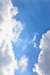 cloud cluster in a clear blue sky on a bright summer day	

