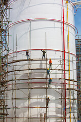 Worker male assembly in progress storage new tank  oil inspection scaffolding