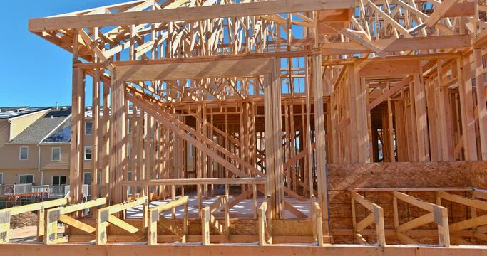 Aerial view of a building under construction, wood stick frame in framing beams for new house