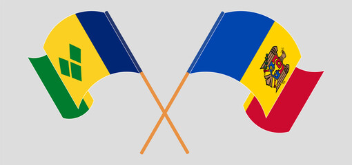 Crossed and waving flags of Saint Vincent and the Grenadines and Moldova