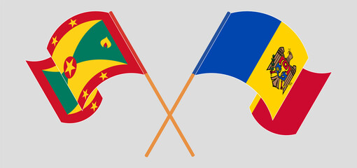 Crossed and waving flags of Grenada and Moldova