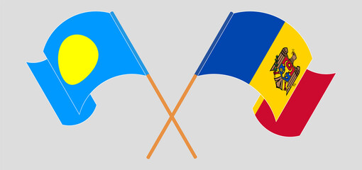 Crossed and waving flags of Palau and Moldova