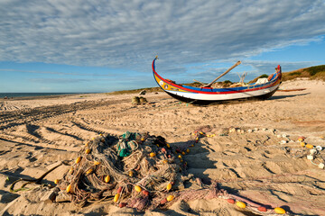 nets and colorful fishing boats on the sand, along the Atlantic, on the beach of Torreira, Portugal